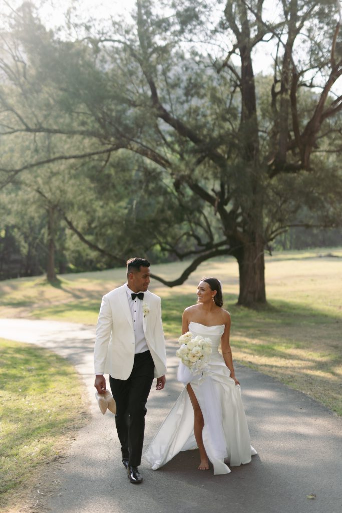 Wedding couple walking through vineyard grounds — placeholder photography