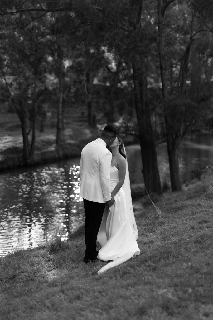 Wedding couple by the creek at dusk — placeholder photography